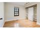 Empty bedroom features hardwood floors, a window, neutral paint, and closet at 7476 Park Lane Rd, Longmont, CO 80503