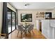 Cozy dining area featuring a modern glass table set, hardwood floors, and natural light at 7476 Park Lane Rd, Longmont, CO 80503