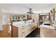 Spacious open-concept kitchen with stainless hood, black backsplash, and eating area at 7476 Park Lane Rd, Longmont, CO 80503