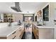 Well-lit kitchen with white countertops, light wood cabinets, hexagon tile flooring, and a seamless flow to dining area at 7476 Park Lane Rd, Longmont, CO 80503