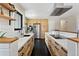 Modern kitchen featuring light wood cabinets, white countertops, stainless steel appliances, and hexagon tile flooring at 7476 Park Lane Rd, Longmont, CO 80503