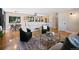 Bright living room with an open floor plan showcases hardwood floors and a stylish transition to the kitchen at 7476 Park Lane Rd, Longmont, CO 80503