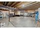 Unfinished basement with exposed ceiling, concrete flooring, and abundant storage space at 18003 E Alamo Dr, Centennial, CO 80015