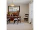 Comfortable dining room showcasing a wooden table set, an accent mirror, and ample natural lighting at 18003 E Alamo Dr, Centennial, CO 80015