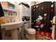 Cozy bathroom features Mickey Mouse shower curtain, mirror, and a sink at 19258 E Kansas Dr, Aurora, CO 80017