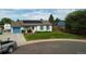Charming single story home boasts a manicured lawn and solar panels for energy efficiency at 19258 E Kansas Dr, Aurora, CO 80017