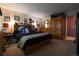 Spacious main bedroom features carpet floors, large window, and a king size bed at 19258 E Kansas Dr, Aurora, CO 80017