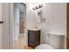 Small bathroom with updated vanity and exposed brick at 2306 Glenarm Pl # 206, Denver, CO 80205