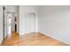A bright bedroom features a spacious closet with sliding doors and hardwood floors throughout at 2306 Glenarm Pl # 206, Denver, CO 80205