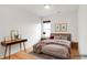 Virtually staged bedroom with hardwood floors and mid-century furniture at 2306 Glenarm Pl # 206, Denver, CO 80205