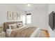 Well-staged bedroom boasts a large bed with a tufted headboard and stylish decor at 2306 Glenarm Pl # 206, Denver, CO 80205