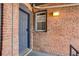 Private entrance with brick facade and dark gray door at 2306 Glenarm Pl # 206, Denver, CO 80205