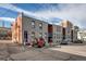 Multi-unit property has reserved parking spaces and a red Jeep parked outside at 2306 Glenarm Pl # 206, Denver, CO 80205