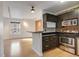 Stylish kitchen and living area featuring sleek cabinets, stainless steel appliances, and wood floors at 2306 Glenarm Pl # 206, Denver, CO 80205