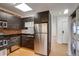 Contemporary kitchen boasting stainless steel appliances, dark wood cabinets, and access to laundry at 2306 Glenarm Pl # 206, Denver, CO 80205