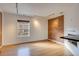 Bright living room with exposed brick wall, hardwood floors, and large window at 2306 Glenarm Pl # 206, Denver, CO 80205