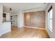 Living room with hardwood floors, exposed brick, and laundry closet at 2306 Glenarm Pl # 206, Denver, CO 80205