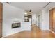 Open living space with brick accent wall, fireplace, hardwood floors, leading to kitchen and laundry at 2306 Glenarm Pl # 206, Denver, CO 80205