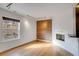 Living room with exposed brick wall, hardwood floors, and a modern fireplace at 2306 Glenarm Pl # 206, Denver, CO 80205