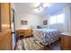 Comfortable bedroom with hardwood floors, stylish rug, and a bright window with natural light at 5973 S Krameria St, Centennial, CO 80111