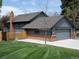 Beautiful home with a spacious yard, wooden fence, and brick chimney creates a cozy, inviting atmosphere at 5973 S Krameria St, Centennial, CO 80111