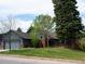 Inviting gray home boasts mature trees and meticulous landscaping, creating a welcoming ambiance at 5973 S Krameria St, Centennial, CO 80111