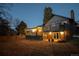 Multi-level deck with outdoor seating and string lights overlooks large backyard with mature trees at 5973 S Krameria St, Centennial, CO 80111