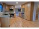 Spacious kitchen featuring wood cabinets, stainless steel appliances, and hardwood floors at 5973 S Krameria St, Centennial, CO 80111