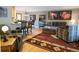 Open-concept living area with hardwood floors, comfortable furniture, and a view into the kitchen at 5973 S Krameria St, Centennial, CO 80111