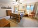Cozy main bedroom with rustic wood furniture, ceiling fan, and a large picture window at 5973 S Krameria St, Centennial, CO 80111