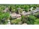 Charming home showcasing a well-manicured lawn, mature trees, and a welcoming red front door at 2453 S Memphis Way, Aurora, CO 80013