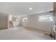 Large finished basement featuring carpet floors, brick fireplace, and two windows at 2453 S Memphis Way, Aurora, CO 80013