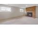 Finished basement with a cozy brick fireplace, carpet floors and bright windows at 2453 S Memphis Way, Aurora, CO 80013