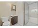 Functional bathroom with a toilet, small vanity, medicine cabinet, and access to a bedroom at 2453 S Memphis Way, Aurora, CO 80013