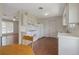 Classic kitchen design with white cabinetry, appliances, and adjacent dining area at 2453 S Memphis Way, Aurora, CO 80013
