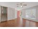 Bright living room with hardwood floors, a large window, and staircase to the upper level at 2453 S Memphis Way, Aurora, CO 80013