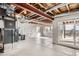 Unfinished basement featuring concrete floor, sliding glass door and exposed ceiling at 14734 Domino Dr, Parker, CO 80134