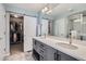 Stylish bathroom with double vanity, modern fixtures, and walk-in closet with sliding door at 14734 Domino Dr, Parker, CO 80134
