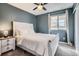 Comfortable bedroom with a ceiling fan, white bedding, and a window for natural light at 14734 Domino Dr, Parker, CO 80134