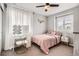 Cozy bedroom with soft carpet, pink accents, and a vanity for getting ready at 14734 Domino Dr, Parker, CO 80134