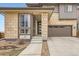 Charming two-story home with brick accents, a covered entry, and a two-car garage at 14734 Domino Dr, Parker, CO 80134