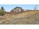 Exterior view of a home with a sloped yard and wooden fencing at 14734 Domino Dr, Parker, CO 80134