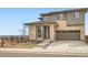 Attractive home with stone accents, a two-car garage, and a well-manicured lawn at 14734 Domino Dr, Parker, CO 80134