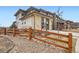 Lovely exterior view of this home with stone accents and a charming wooden fence at 14734 Domino Dr, Parker, CO 80134