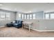 Open living area with large windows, comfortable seating, and neutral color palette at 14734 Domino Dr, Parker, CO 80134