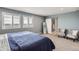 Relaxing bedroom with plantation shutters, calming color palette and ensuite bathroom with a sliding barn door at 14734 Domino Dr, Parker, CO 80134