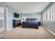 Spacious bedroom with neutral carpet, stylish furniture, and window with wooden shutters at 14734 Domino Dr, Parker, CO 80134