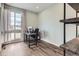 Bright home office with hardwood floors, large window, and built-in shelving at 14734 Domino Dr, Parker, CO 80134