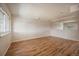 Spacious basement with hardwood flooring, white painted brick accents, and natural light at 6800 E Tennessee Ave # 533, Denver, CO 80224