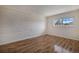 Bright bedroom featuring hardwood floors and white brick accent wall, and a window at 6800 E Tennessee Ave # 533, Denver, CO 80224